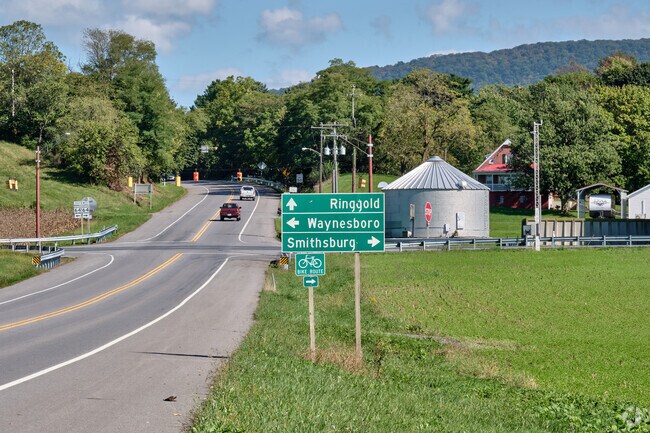 A sign at a crossroads points the way to three larger towns in the region.