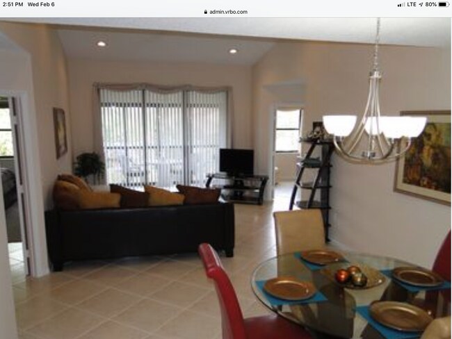 Living and Dining Area with recessed lighting, vaulted ceiling, and view of pond.