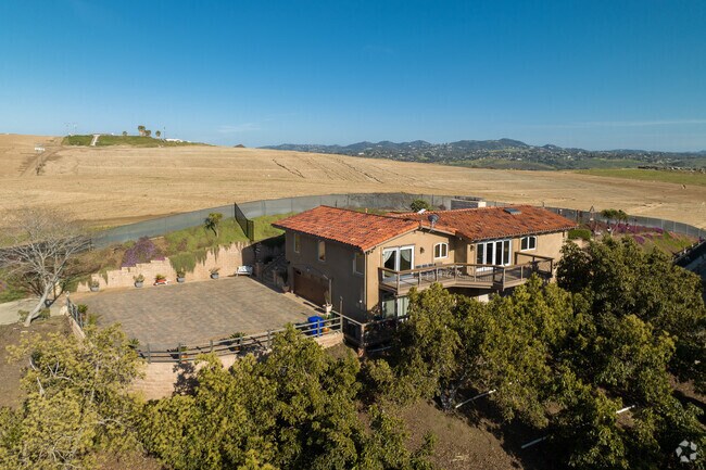 Custom built two story Mediterranean styled home with acres of land at the top of South Morro Hills.