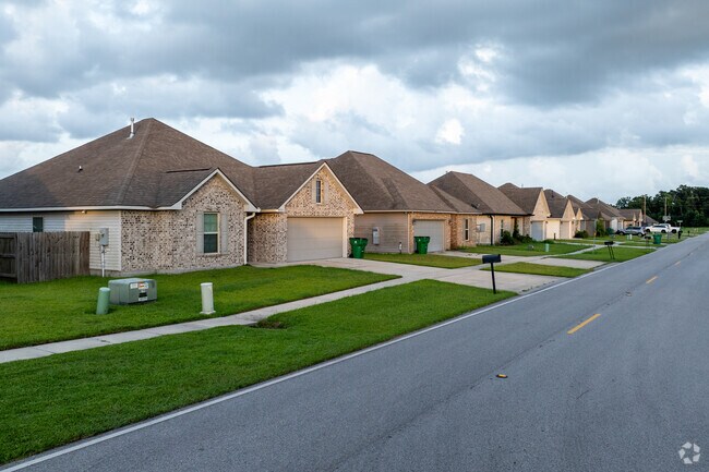 Newly built brick ranch and Acadian homes line the streets of Estelle.