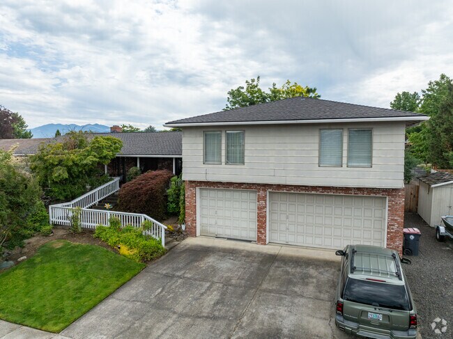 Most streets feature well-maintained sidewalks and evergreen trees.