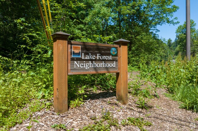 A bright wooden sign welcomes residents to the Lake Forest neighborhood on Waluga Drive.