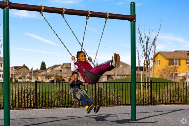 Children's laughter on swings in Lone Tree Valley.