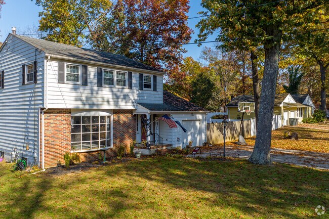 Traditional 2-story colonial revivals in Newfield welcome natural light with huge bay windows.