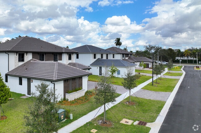 Newly planted trees line the Sunshine Village neighborhood sidewalks.