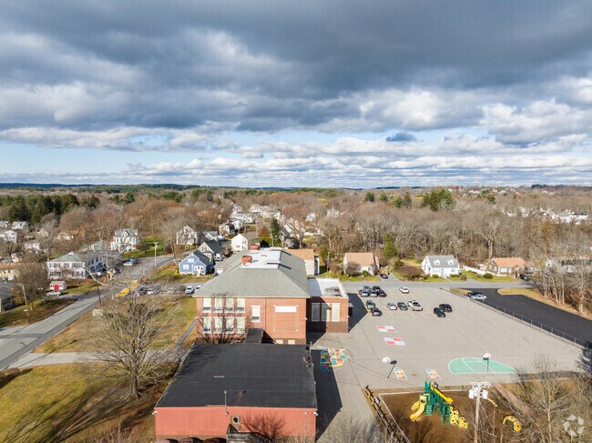Greenmont Elementary School has a large blacktop playground and jungle gym.