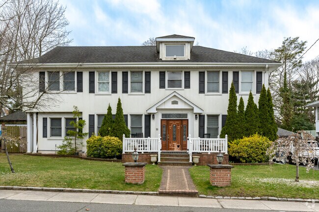 An wide variety of green trees and bushes can be seen throughout the neighborhood as homeowners get creative