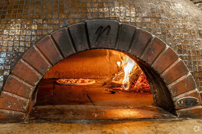 Pizzas are baked in the artisanal oak-fired oven at Fiammé in North Downtown Naperville.