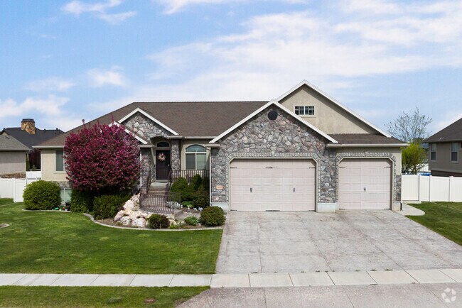 A beautiful home with stone work and a beautifully landscaped yard in Pleasant View.