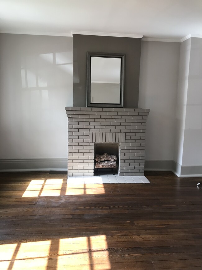 Living room, original Black Walnut floors, decorative fureplace