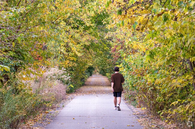 A Pleasant Hills resident takes a leisurely walk at Constitution Trail in Normal, IL.