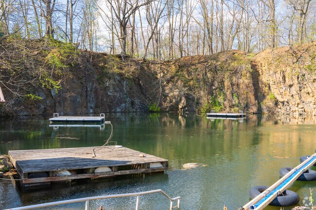 The Quarry Swimming Club has an area for people to swim and volleyball net.