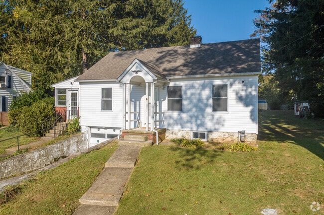 A classic Cape Cod residence showcases a welcoming portico that provides protection from rain and sun.