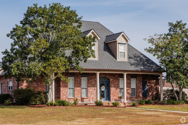 Found in North Lafayette Parish, a French-inspired home with a blue front door.
