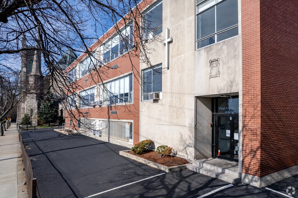 The Paul Cuffe Middle School Has a Faithful and Symmetrical Building  in The West End Providence Neighborhood