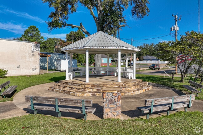 There is a gazebo and benches in the town square.