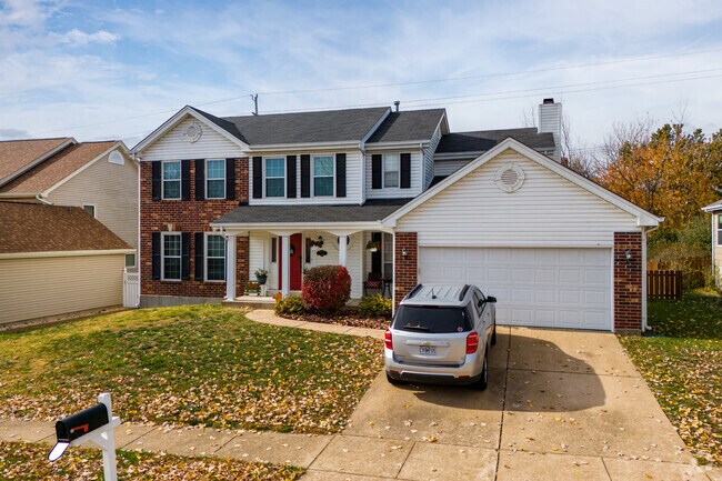 An older colonial style home with distinct white columns in Oakville.