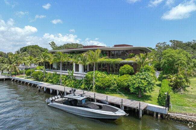 Contemporary waterfront property with a speedboat in the Colee Hammock neighborhood.