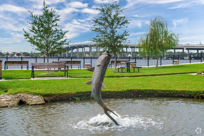 Rockefeller Gardens in Ormond By The Sea features a statue honoring local fishing heritage.