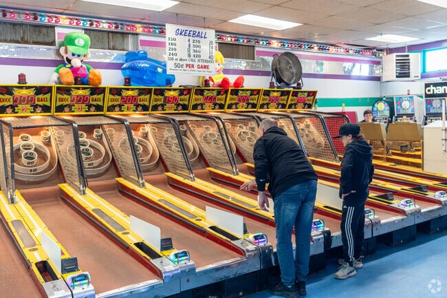 A couple of people play skeeball at Joe's Playland near Salisbury.