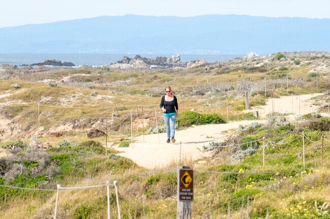 A lady going on a walk in the Pacific Grove neighborhood.