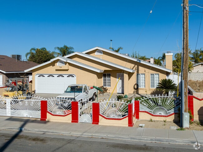 A white iron fence adds character to this mid 20th century home in West Delano.