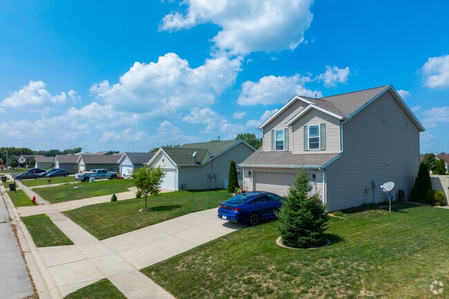 Sidewalks and garages line residential streets in Rensselaer.