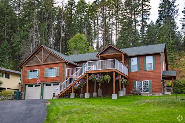 Two story log cabin homes with front porches offer outstanding views of the valley below.