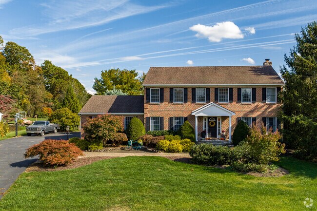 Well-maintained lawns and large driveways are common in Holly Hills.
