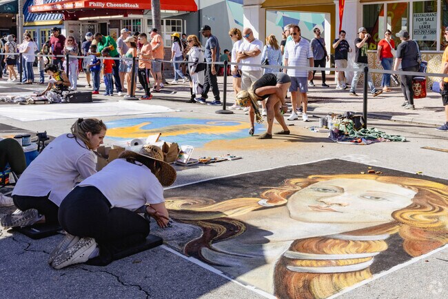 Bryant Park locals enjoying the hard working street artists at the fair.