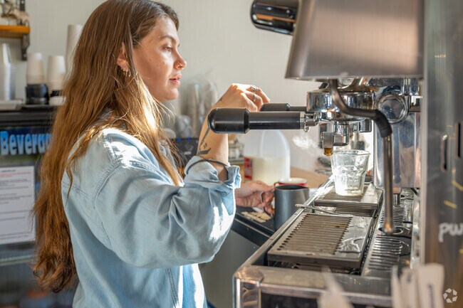 The professional barista at Buvez has mastered the art of making lattes in Newtown.