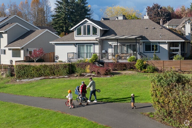 Families enjoy the paved path around Summer Lake.