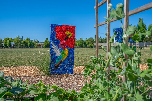 Student art made with recycled materials hangs in the garden at Quatama Elementary in Hillsboro.