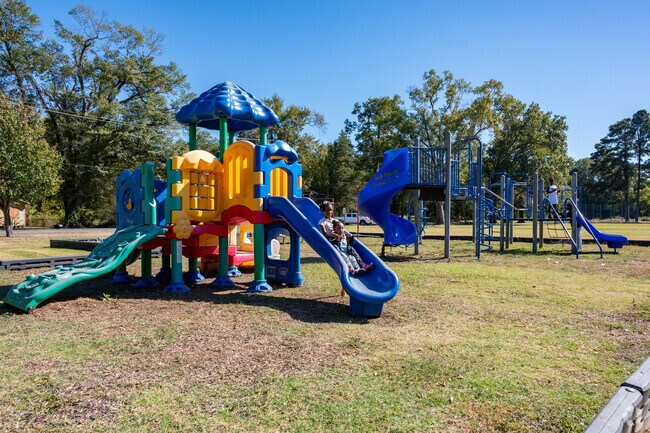 Siblings take a slide turn together at Lida Benton Playground.