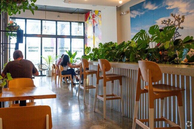 The interior of Harpers Juice shows patrons enjoying their meals.