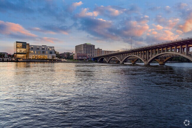 The Rockford Public Library, across the Rock River, illuminates in the evening.