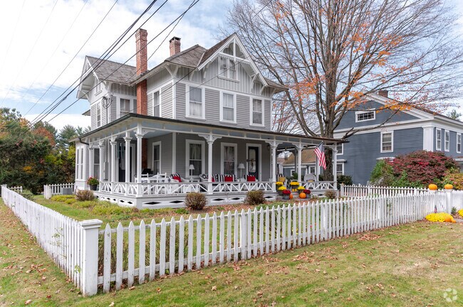 Picket fences and porches line this classical home on Main Street.