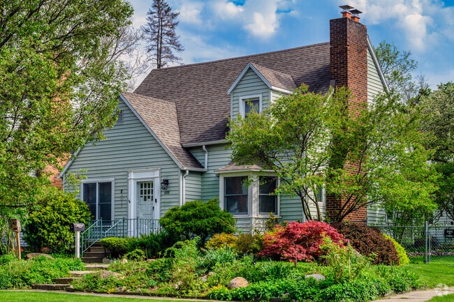 A beautiful Cape Cod style home sits on the corner of a quiet street in Clifford Park.