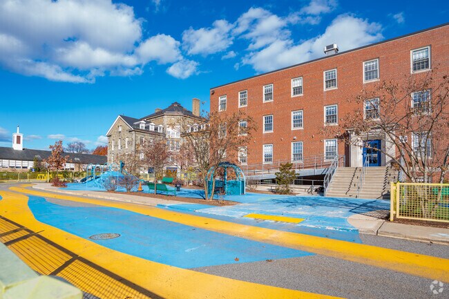 A large play area sits outside the International School of Boston Elementary building.