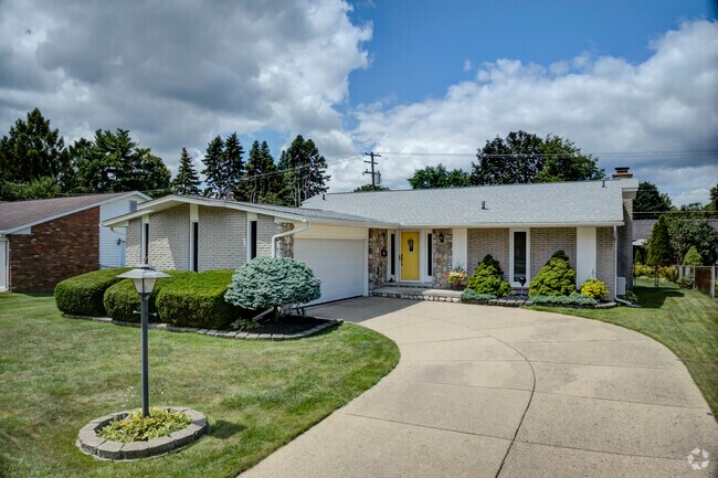 Brick Ranch-style home with a tidy lawn in Livonia.