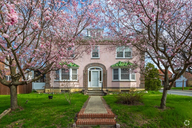 A lovely pink two-story home with matching cherry blossom trees in Hedgesville, Wilmington, DE.