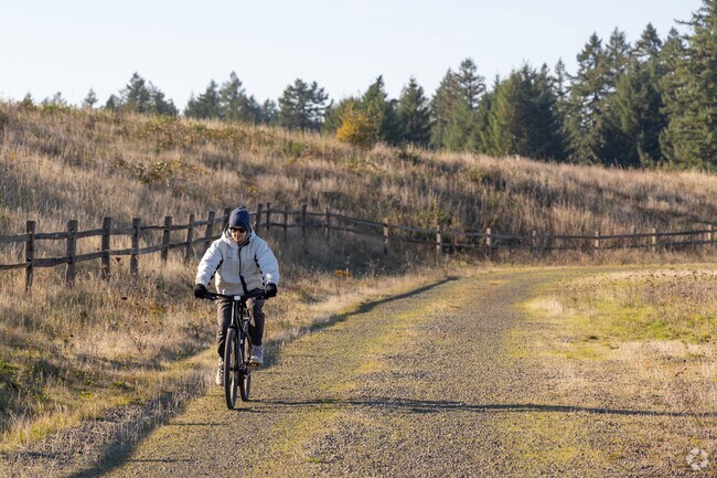 A cyclist rides along a path in Powell Butte Nature Preserve.