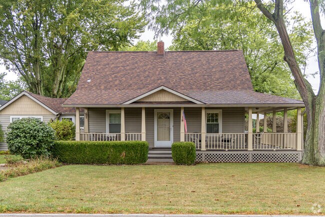 A large front porch wraps around this traditional styled home in Yorktown, IN.