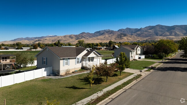 Peaceful suburban street in Hyde Park, where cozy homes sit beneath the striking backdrop of the Cache Valley mountains.