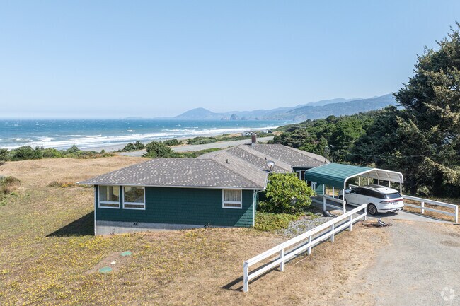 Hidden by towering pine trees, some homes have views of the pacific.