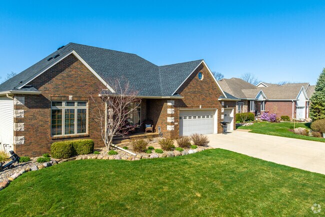 Gabled brick homes back up to the Green Fairways of Copper Creek Golf Course.