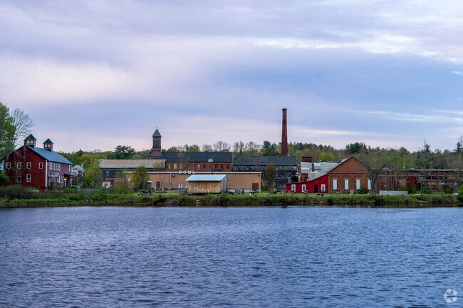 Former toy factories next to Hunts Pond in Winchendon glow as the sun sets.