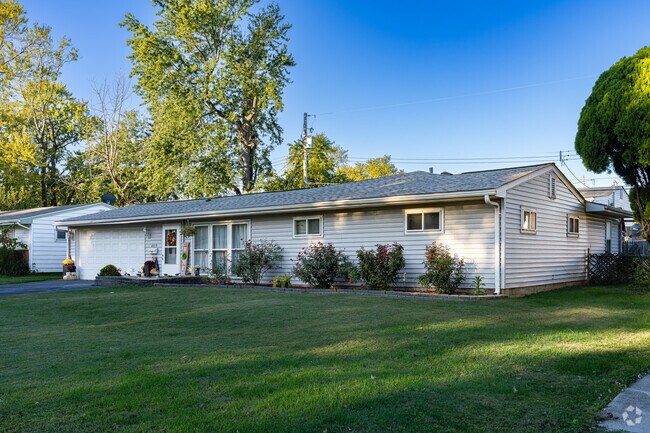 An early 20th century Ranch style home with large green yard in Woodson Terrace.