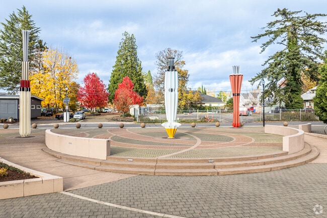 Four abstract pillars of varying shapes and colors stand tall in the Arts Plaza.