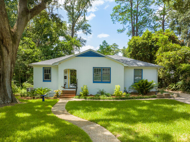 A mature oak tree shades this neatly kept bungalow.